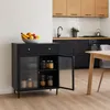 A modern kitchen with a black sideboard, wooden cabinets, and a dining table. Podgląd zdjęcia produktu