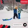 Two children pulling a sled in the snow. Voir les images du produit