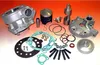 A collection of motorcycle engine parts, including a cylinder, piston, gaskets, and bolts, laid out on a surface. Podgląd zdjęcia produktu