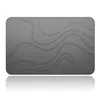 A dark gray bath mat with a wavy, embossed texture, shown in a studio shot with a reflection. Produktbild-Vorschau