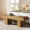 A wooden bench is placed in front of a bed in a bedroom. Voir les images du produit