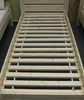 A wooden bed frame with slats, showing the base of the bed without a mattress. Another bed frame is partially visible on the left. Podgląd zdjęcia produktu