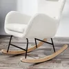 A close-up shot of a white, fluffy rocking chair with black metal legs and a wooden base, set against a light gray and white background. Produktbild-Vorschau
