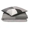 A folded duvet and pillow with a geometric pattern. Produktbild-Vorschau