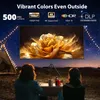 Two people are watching a projector screen outdoors at night, with a tent and string lights in the background. Náhled obrázku produktu