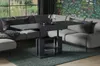 A modern living room with a sectional sofa and a functional coffee table. Voir les images du produit