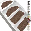 Several brown stair mats are placed on white stairs. Produktbild-Vorschau