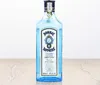 A bottle of Bombay Sapphire Dry Gin is displayed on a wooden surface against a white background. Produktbild-Vorschau