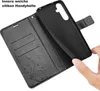 A hand is holding a black phone case, showing its interior and the wallet part of the case. Produktbild-Vorschau