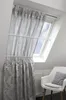 A white chair sits next to a window with a curtain and a radiator below. Produktbild-Vorschau