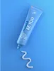 A tube of Curaprox toothpaste is shown on a blue background with a swirl of toothpaste on the surface. Náhled obrázku produktu
