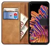 A book-style phone case is open, showing a card slot with a bank card and two euro banknotes tucked inside. The phone is visible on the right side, displaying a colorful abstract wallpaper. Náhľad obrázku produktu
