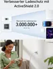 A woman is using a smartphone while a charger is plugged into a wall outlet. Anteprima dell’immagine prodotto