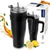 A black thermos with a handle and straw, shown next to its packaging and some lemons and leaves. Náhled obrázku produktu