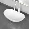 A white ceramic vessel sink with a modern white faucet and soap dispenser sits on a dark gray marble countertop. Náhľad obrázku produktu