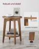 A wooden side table with a cup, a framed picture, and books on it, with close-up insets showing table thickness and adjustable feet. Produktbild-Vorschau