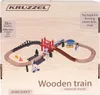 The image shows the packaging of a wooden train set, with the toy train and track layout depicted on the box. Voir les images du produit