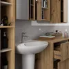 A modern bathroom vanity with a sink and faucet, set against a marble-patterned backsplash. Wooden cabinets and shelving are visible. Podgląd zdjęcia produktu