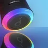 Close-up of a black Soundcore Bluetooth speaker with a colorful LED light ring around the base, reflected on a glossy surface. Produktbild-Vorschau