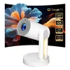A white projector with a glowing light on its stand, set against a dark background with abstract, colorful floral imagery. Text overlays highlight product features. Produktbild-Vorschau