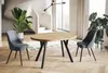 A modern dining room scene with an extendable wooden table and two grey chairs. Produktbild-Vorschau