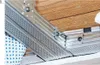 A close-up view of metal construction components being assembled with a tool. Anteprima dell’immagine prodotto
