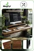 A desk setup with a monitor, keyboard, and plants, showcasing a monitor stand. Podgląd zdjęcia produktu