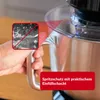 A hand is holding the handle of a kitchen appliance, with a close-up inset showing a splash of liquid being prevented by a splash guard. Produktbild-Vorschau