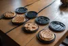 Several waffle molds and freshly made waffles are arranged on a wooden table. Produktbild-Vorschau