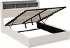 A white upholstered bed frame with its mattress support mechanism lifted, revealing storage space underneath. The headboard has built-in shelves. Produktbild-Vorschau