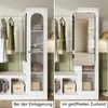 A split image showing a white wardrobe/storage unit in two states: closed and open, with clothes hanging and items stored inside. Produktbild-Vorschau