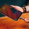 A person is holding a tablet and inserting a USB drive into it. Náhľad obrázku produktu