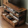 A TV stand with multiple shelves and drawers, displaying electronic devices and decorative items. Podgląd zdjęcia produktu