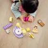 A child playing with LEGO DUPLO blocks on a wooden floor. Náhľad obrázku produktu