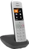 A white and gray Gigaset cordless phone is shown in its charging base against a white background. Podgląd zdjęcia produktu