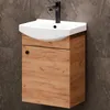 A close-up shot of a bathroom vanity with a sink and faucet against a tiled wall. Produktbild-Vorschau