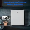 A white Medion mini-refrigerator is shown on a kitchen counter, with cabinets in the background. Produktbild-Vorschau