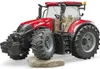 A red toy tractor is shown on a white background, with a rock underneath the front wheel. Podgląd zdjęcia produktu