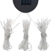 A close-up view of the top part of a solar-powered LED string light set, showing the solar panel and three bundles of lights. Produktbild-Vorschau