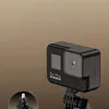 A black GoPro camera is mounted on a tripod mount, with a small inset image showing a connector. Voir les images du produit
