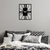A bedroom scene with a clock on the wall and pillows on the bed. Podgląd zdjęcia produktu
