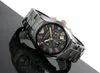 A black ceramic Emporio Armani chronograph watch with gold accents is displayed on a reflective black surface against a white background. Produktbild-Vorschau