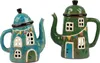 Two decorative teapots shaped like houses, displayed side-by-side against a white background. Produktbild-Vorschau