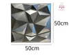 A 3D wall panel with a geometric design, shown on a white background with size indicators. Produktbild-Vorschau