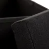 A close-up view of the corner of a black fabric storage box. Náhled obrázku produktu