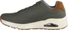 Side view of a single green sneaker with a white sole and brown accents. Voir les images du produit
