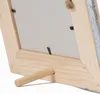 Close-up view of the back of a wooden picture frame, showing the stand. Voir les images du produit