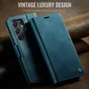 A blue leather flip phone case is shown with the phone inside, displaying its camera array. The case is open, revealing the phone's back and side. The background is a textured brown surface, possibly leather or wood. Produktbild-Vorschau
