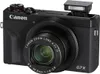 A black Canon PowerShot G7 X Mark III digital camera is shown from the front with its pop-up flash extended. Produktbild-Vorschau