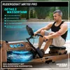 A man is using a wooden rowing machine next to a swimming pool. Produktbild-Vorschau